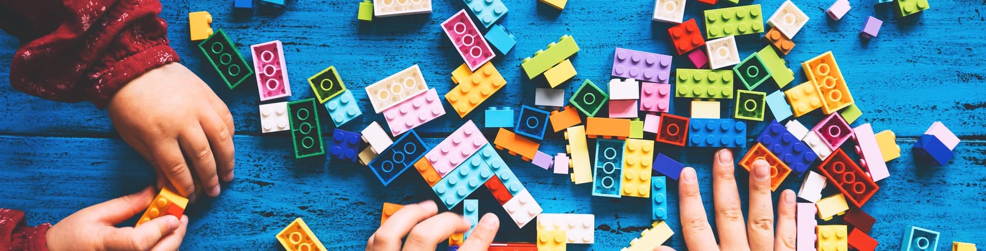 Children Play Build With Colorful Toy Bricks Plastic Blocks Table